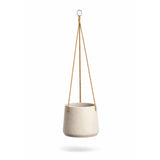 Grey washed hanging Patt planter by Pottery Pots with plants, showcasing its elegant design and texture.