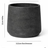 Patt Black Washed 3-piece set of black concrete planters by Pottery Pots against a neutral background.